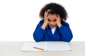 "Stressed Out Primary Girl Child Holding Her Head" by stockimages on freedigitalphotos.net