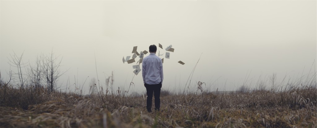 Guy throws papers in a field by Jake Melara from stocksnap.io