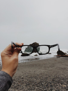 Person holding eyeglasses in the rain by Colby Schenck from stocksnap.io