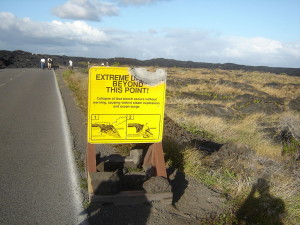 Lava-damaged Hawaiian Sign by Kip Robinson, public domain