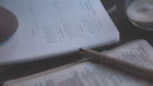 Person writing in Planner by Brandon Redfern from stocksnap.io