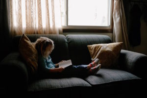 Reading child on couch by Josh Applegate from stocksnap.io