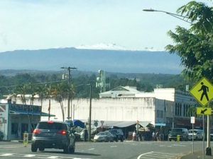 View of snowy Mauna Kea from downtown Hilo by Judy K. Walker