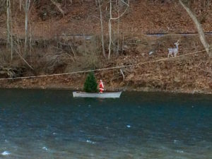 Santa on boat in river by Paul Normann