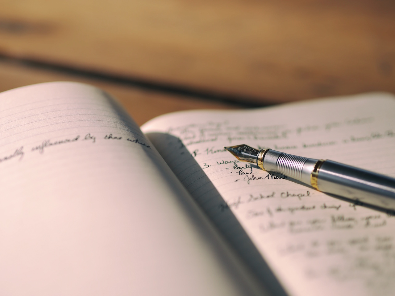 Handwritten notes in a journal by Aaron Burden from stocksnap.io