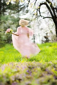 Woman running through woods