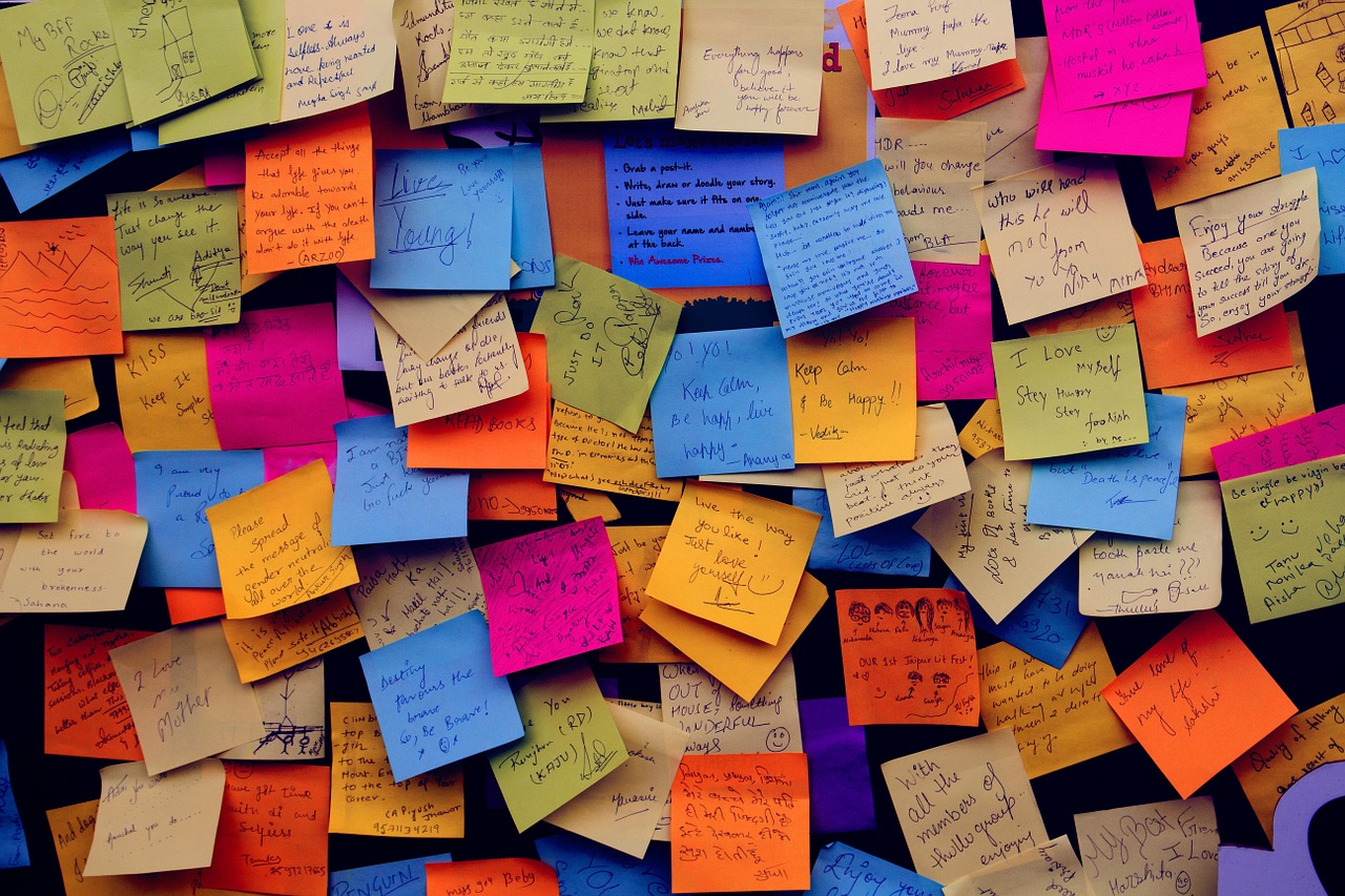 Numerous sticky notes overlapping on a wall