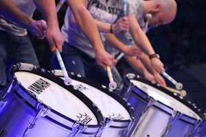 Three college men drumming