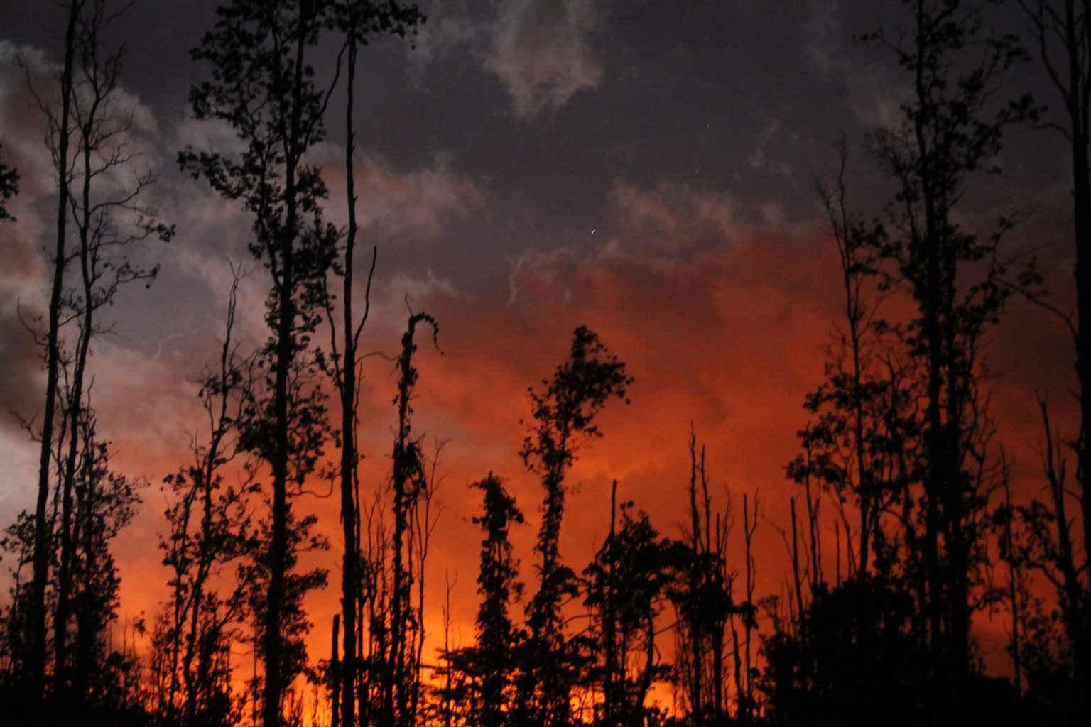 View of the night sky with lava glow in lower Puna, Hawaii Island, on May 30, 2018